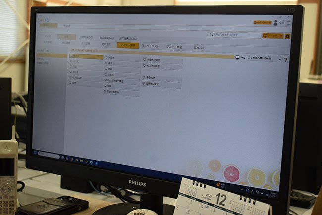 売上・売掛から仕入・買掛、在庫管理までの全般をカバーする業務システムの画面。女性従業員の一人は「見やすく、操作しやすい」と話す