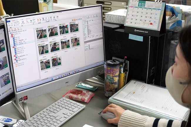 写真整理に取り組む事務担当の従業員