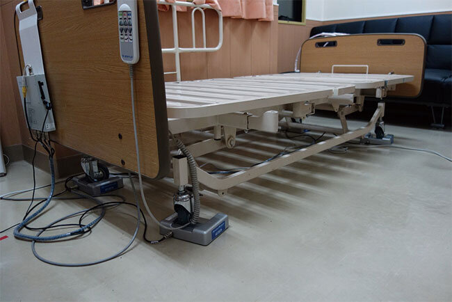 ベッドの脚にセンサーを装着する見守りロボットシステム