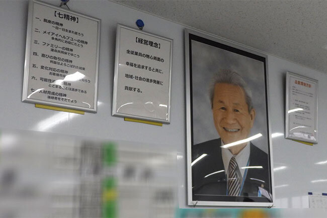 幸手支店の事務フロアには創業者の写真とともに企業理念が掲げられている