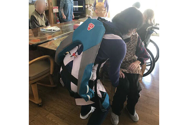 アシストスーツを装着して介護する職員