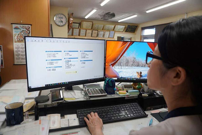 勤怠管理システムで従業員の勤務状況を確認する様子