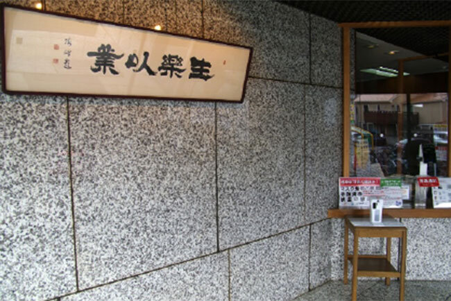 岩堀建設工業本社入り口に掲げられた「業を以て楽しく生きる」の額