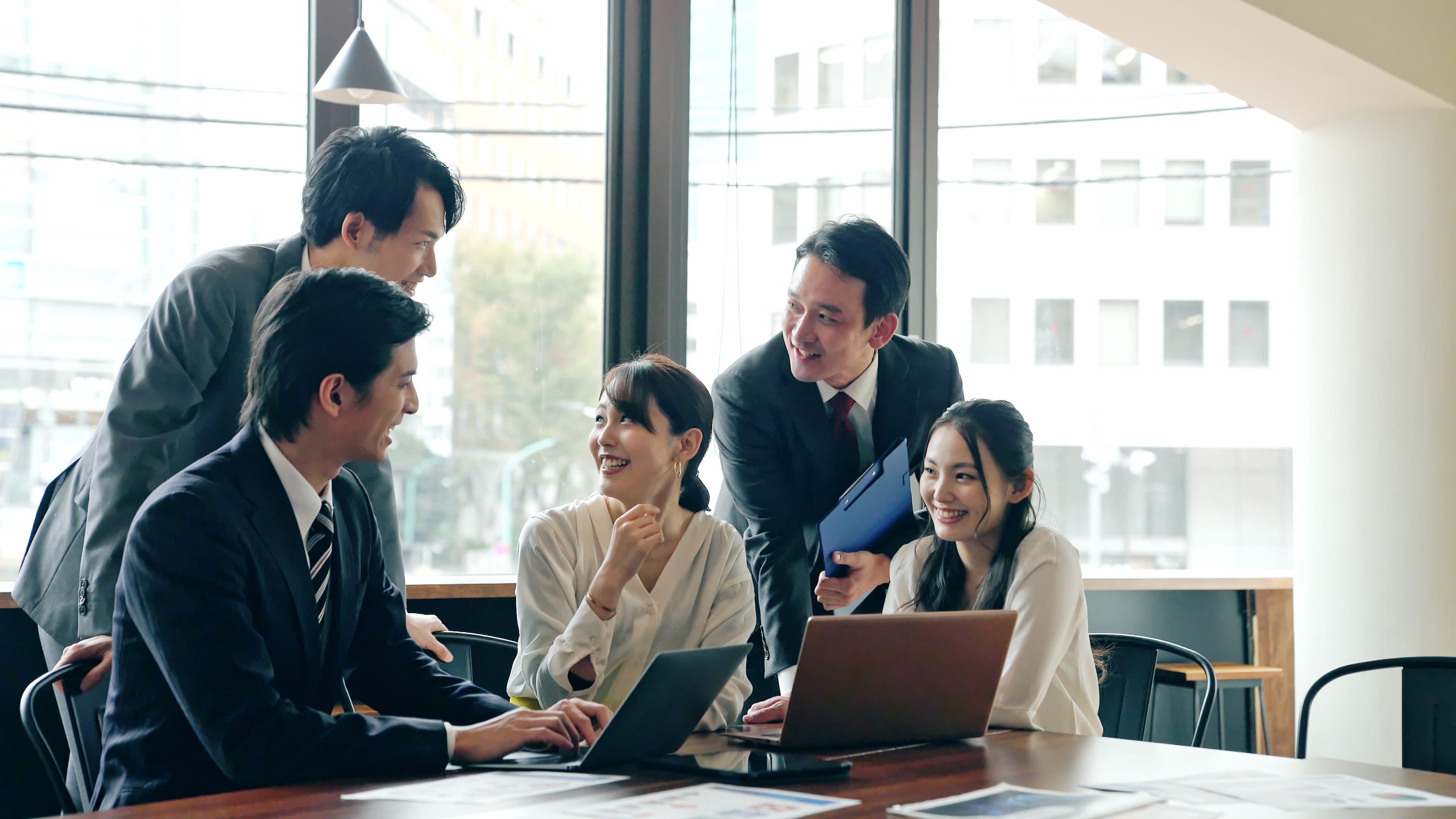 オフィスで会社メンバーと話し合いしている画像