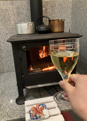 ワイン片手に薪ストーブの炎を楽しむかつあきさん